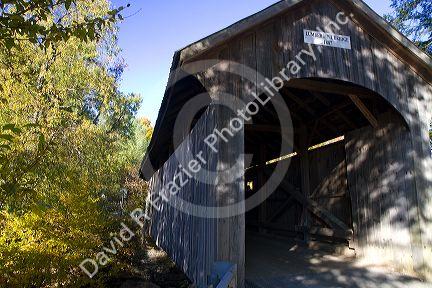 The Mill Covered Bridge crossing the Lamoille River in Belvidere, Vermont, USA.
