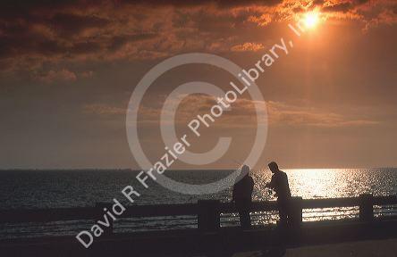 A couple fishing on the causeway fishing bridge near Tampa,Florida at sunset.