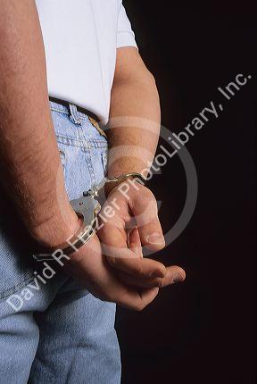 A view from behind of a man in handcuffs.