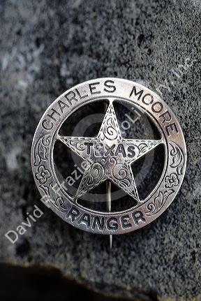 A distinctive circle and star Texas Ranger badge belonging to Charles Moore.