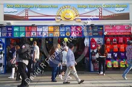 T-shirt vendor selling souvenirs at Fishermans Wharf in San Francisco, California, USA.