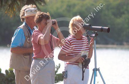 Senior citizens looking through spotting scopes at the J.H. Ding Darling National Wildlife Refuge on Sanibel Island, Florida.