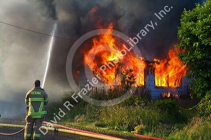 Firefighters working a training fire at Rockaway Beach, Oregon, USA.
