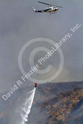 Helicopter dropping water on a wildfire near Boise, Idaho, USA.