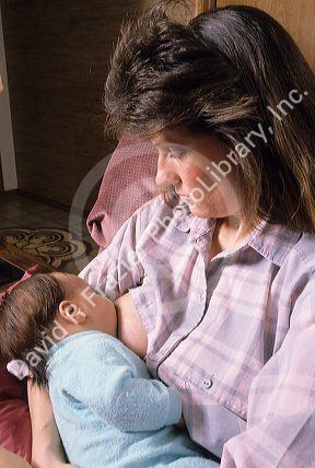 A new mother breast feeds her baby.  (released)