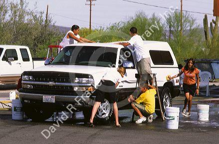 High School teens washing cars as fund raiser for the band at Ajo, Arizona.