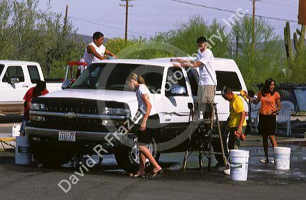 High School teens washing cars as fund raiser for the band at Ajo, Arizona.