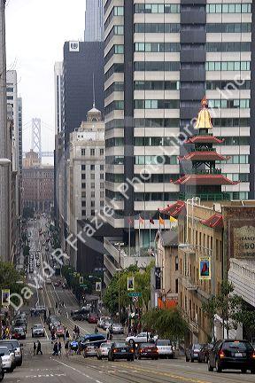 California Street  with traffic in, San Francisco, California.  The bay bridge tower is in the background.