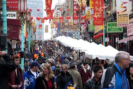 People walking and shopping in Chinatown, San Francisco, California during street festival at Chinese New Year.