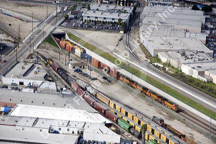 Aerial view of a train coming out of the Long Beach Corridor, Los Angeles, California.  Giant ditch allows trains to pass below grade level and avoid any crossing conflicts with autos.