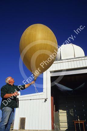 Meteorologist launching a weather balloon.