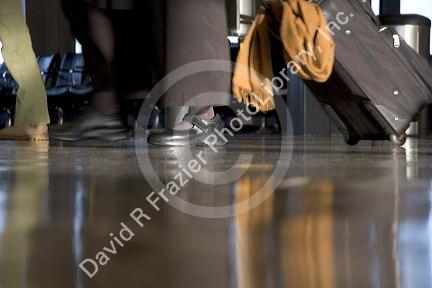 Feet walking at an airport.