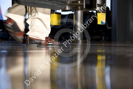 Feet walking at an airport.