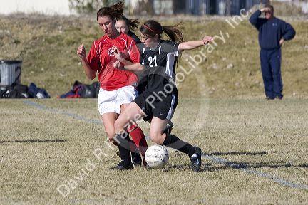 Girls playing soccer.