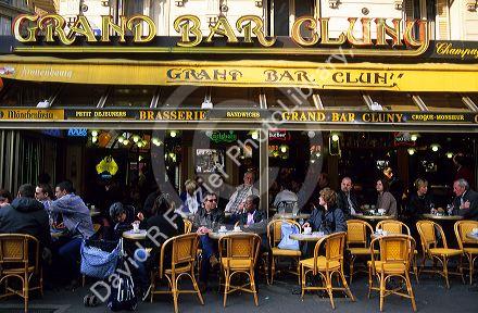 Customers dine at an outdoor cafe in Paris, France.