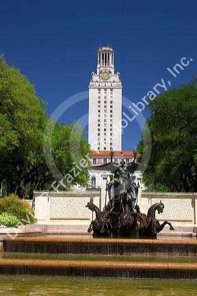 A fountain on the campus of University of Texas in Austin with the clock tower in the background.