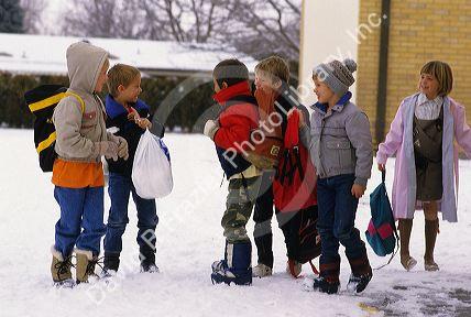 Children dressed for cold weather and snow.
