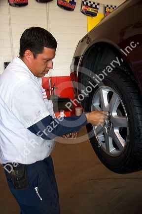 Installing tire on automobile.