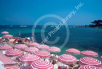 Antebes Cape on the French Riviera with red and white umbrellas.