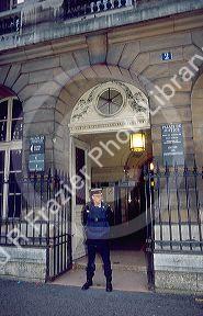 Policeman stands guard in front of the entrance to court in Paris, France.