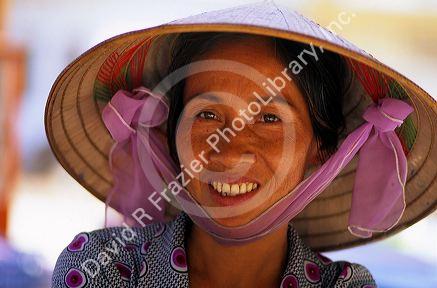 Portrait of a vietnamese woman wearing a traditional hat.