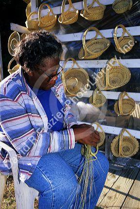 African american woman making sweet grass baskets in Charleston, South Carolina.