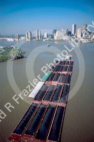 Tug boat and barge tow of coal on the Mississippi River at New Orleans, Louisiana.