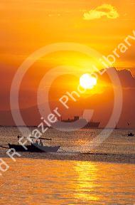 Ships at anchor in Manila Bay, Philippines at sunset.