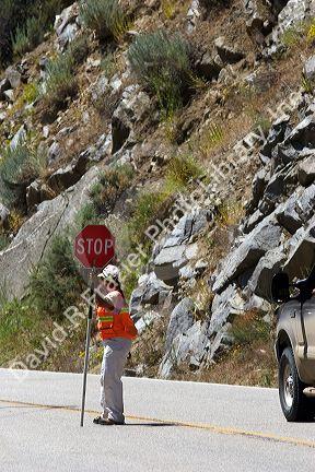 Female flagger stopping traffic for road construction in Idaho.