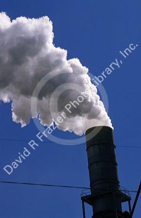 Smoke stacks emit air pollution at a manufacturing plant.