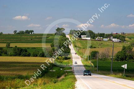 Automobiles travel along US 6, a rural two lane road in west central Iowa.