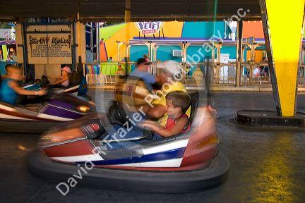 Children and adults ride bumper cars at the Iowa state fair in Des Moines.