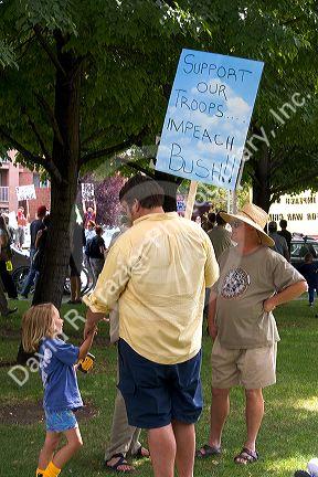 Man holding a sign at an Anti-war protest in Salt Lake City, Utah. 8/22/2005