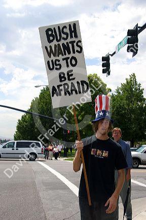 Man holding a sign at an Anti-war protest in Salt Lake City, Utah. 8/22/2005