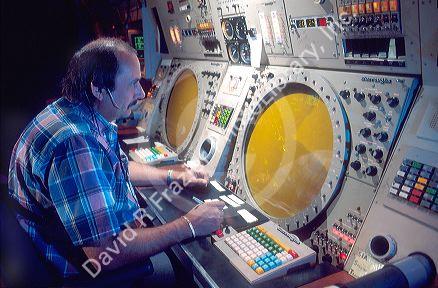 Male air traffic controller working with radar equiptment.
