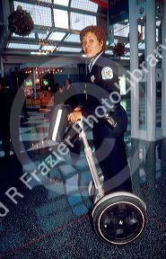 Female Chicago police officer riding a Segue gyro scooter at O'hare airport.