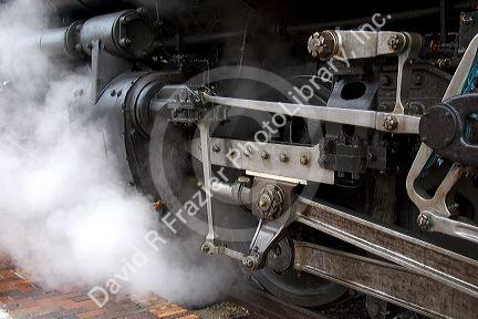 Close view of historic Challenger locomotive steam engine. Drive wheels and pistons.