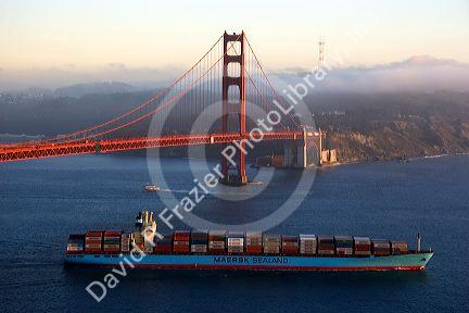 A container ship passes under the Golden Gate Bridge in the San Francisco Bay, California.