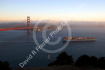 A container ship passes under the Golden Gate Bridge in the San Francisco Bay, California.