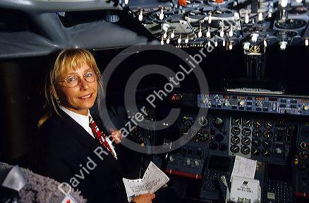 Female airline pilot in the cockpit of a Boeing 737 commercial airplane. MR