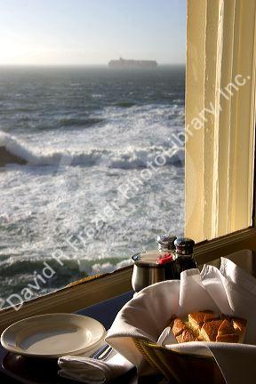 A view of the ocean with a quarter loaf of sour dough bread at The Cliff House Restaurant on the San Francisco Coast, California.