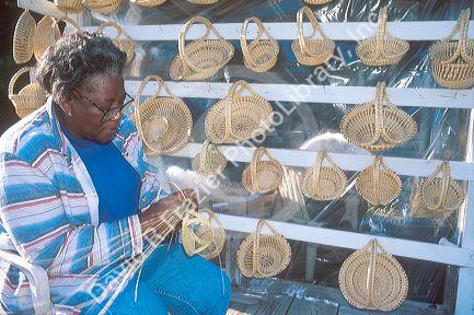 African american woman making sweetgrass baskets in Charleston, South Carolina.
