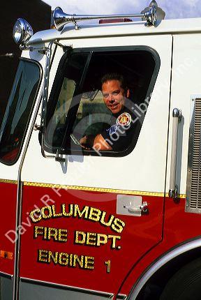 A fireman in the driver's seat of a fire truck in Columbus, Georgia.