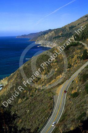 Automobiles drive on highway 1 along the pacific coast in Big Sur, California.