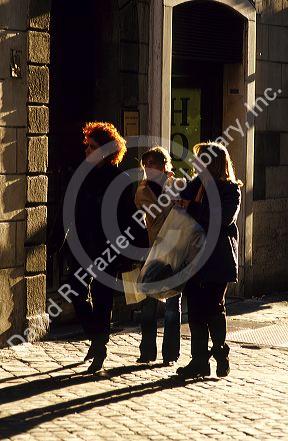 Pedestrians walking along the Via Della Croce in Rome, Italy.