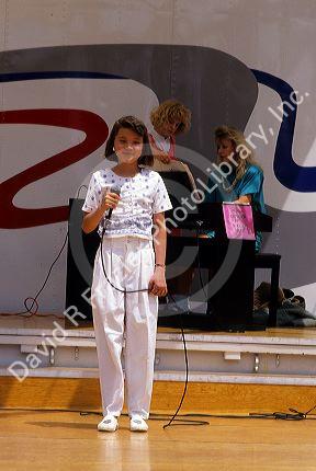A young female singer on stage.