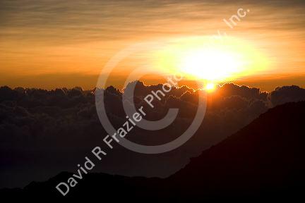 Sunrise above the clouds atop Mount Haleakala on the island of Maui, Hawaii.