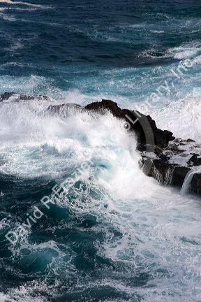 Waves crash in the pacific ocean off the island of Maui, Hawaii.
