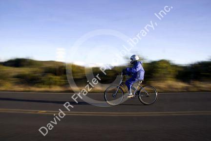 Tourists ride bicycles down Mount Haleakala on the island of Maui, Hawaii.
