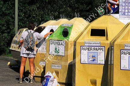 A woman depositing bottles in recycling bins in Munich, Germany.